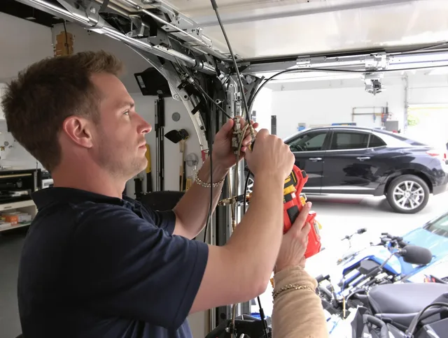 Cleveland Garage Door Repair safety certified technician performing cable replacement in Cleveland
